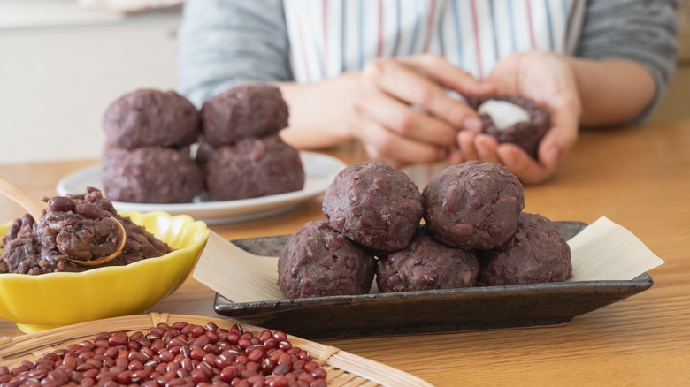 A woman shapes ohagi