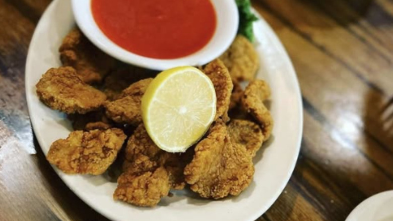 A plate of lamb fries with dipping sauce