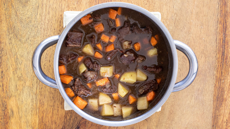 beef, potatoes, carrots in pot