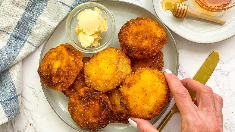 plate with cornbread patties and butter