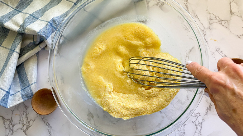 mixing cornbread dough in bowl