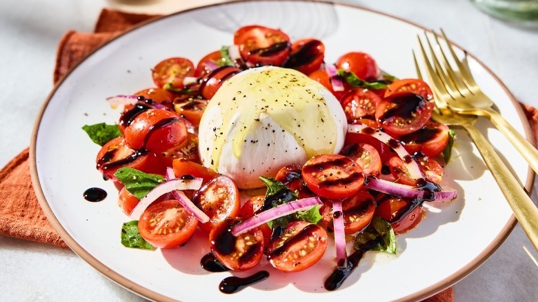 Carrabba's Caprese salad with two forks on plate