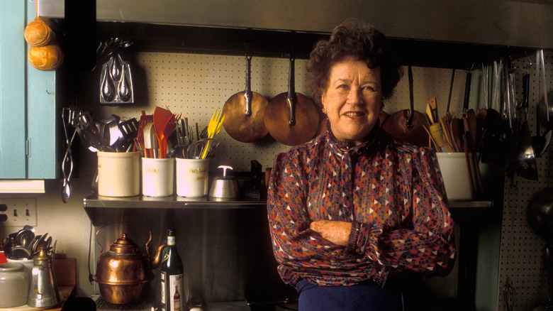 Julia Child smiling in kitchen