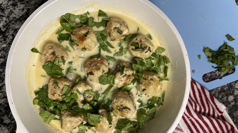 meatballs and spinach in sauce