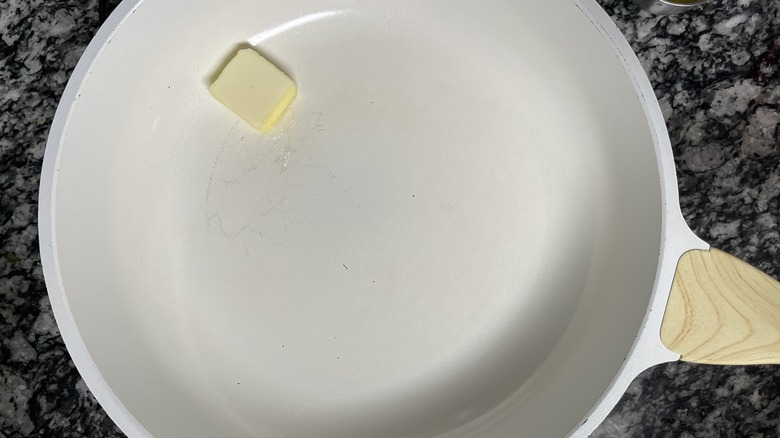 butter in white frying pan