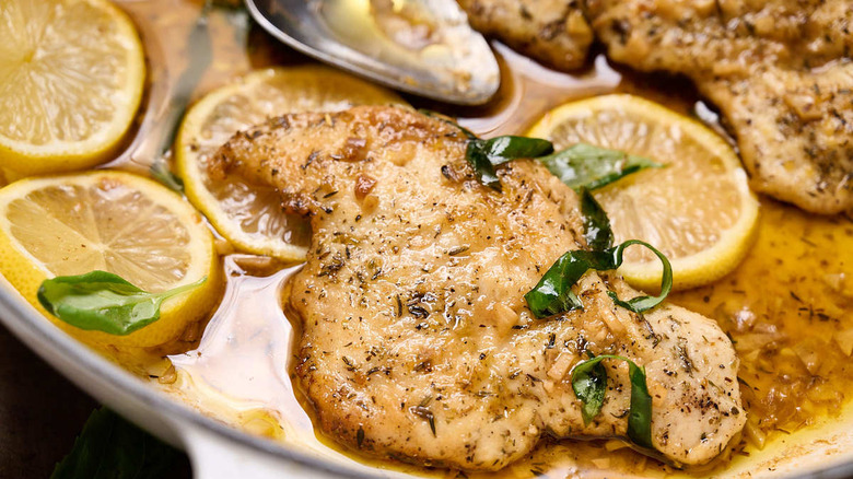 chicken with basil and lemon in pan