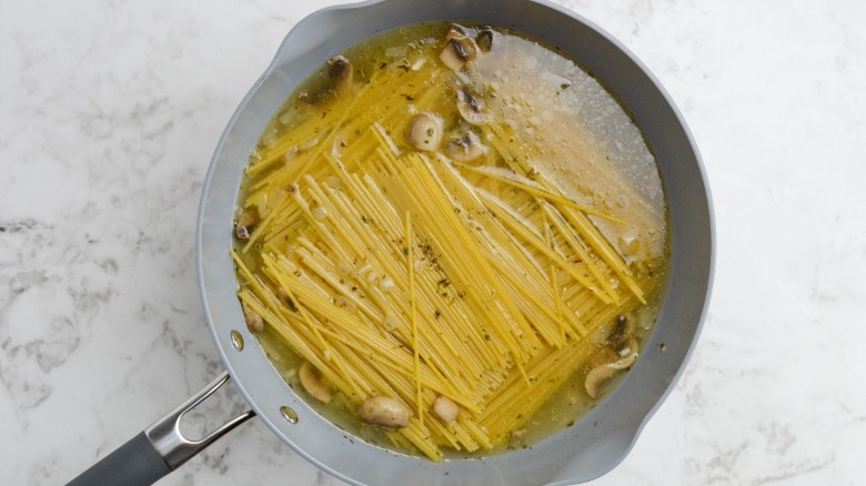 spaghetti and broth in pot