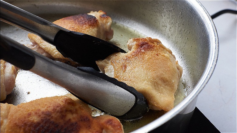 browning chicken in a skillet