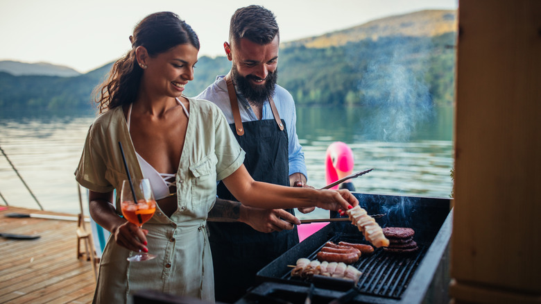 couple cooking with cocktails