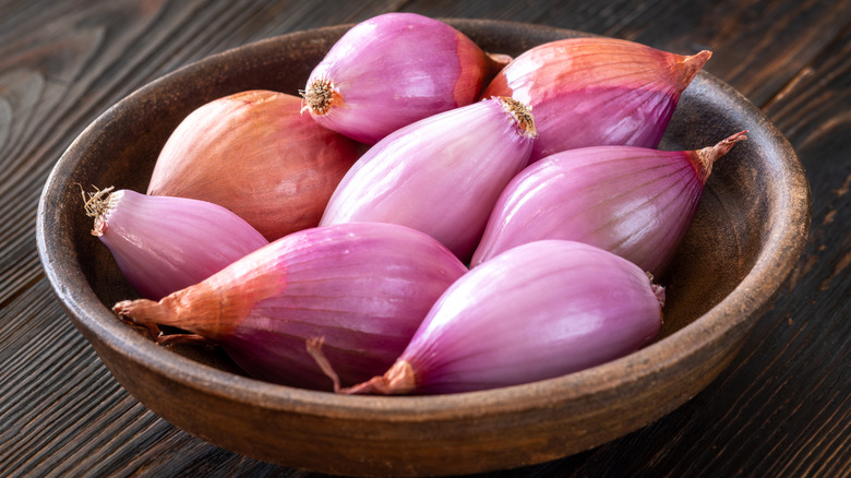 Bowl of shallots on a wooden table