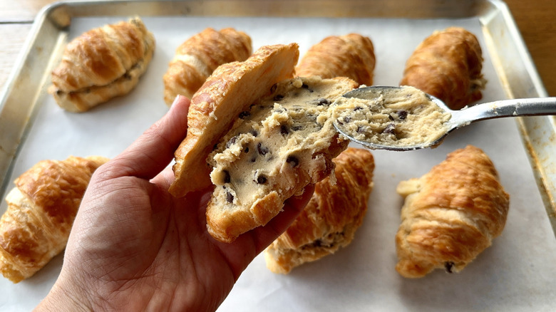 Spreading cookie dough into croissant