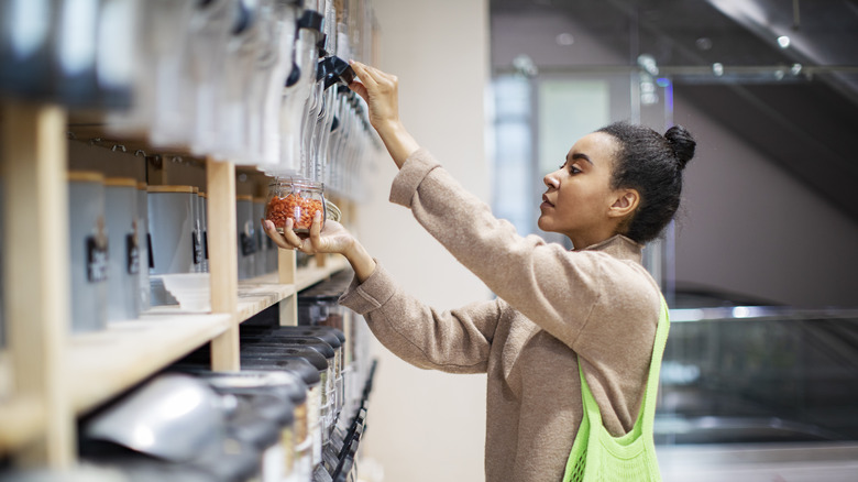 Woman shops in bulk foods aisle