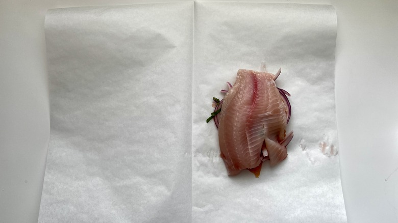 tilapia fillet on parchment paper