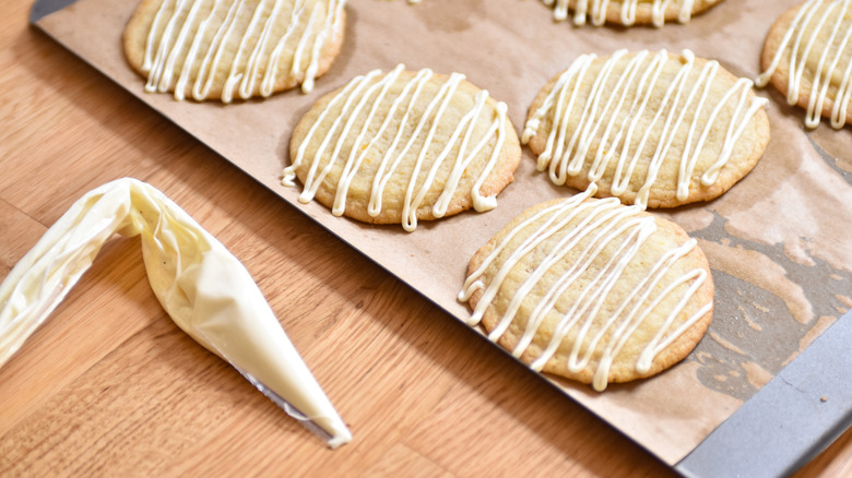 drizzling white chocolate on cookies