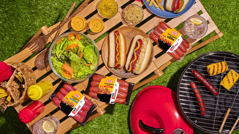 Top-down view of plant-based Oscar Mayer hot dogs with picnic food