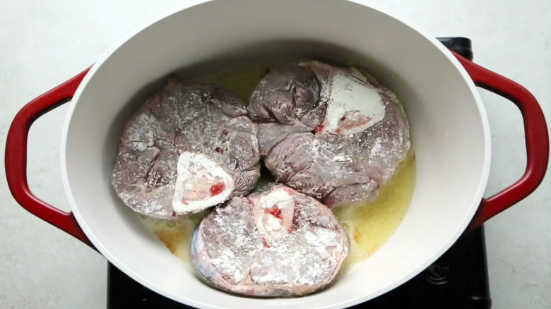 floured beef shanks in pot