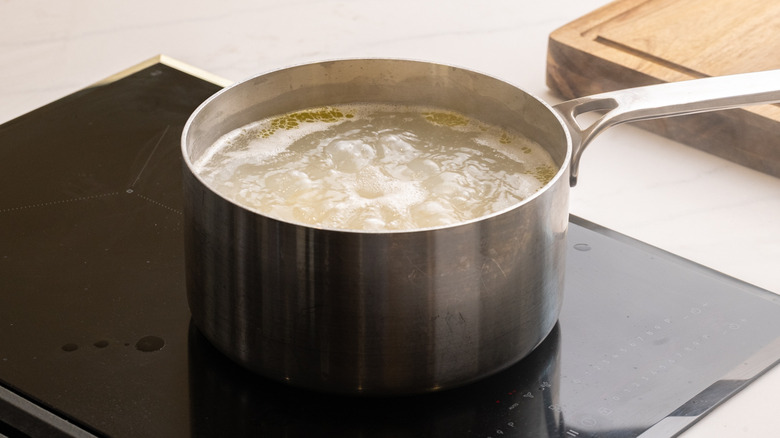 Macaroni noodles cooking in pot of water