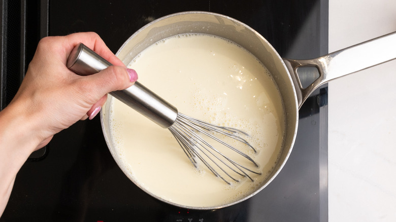 Whisking milk into roux