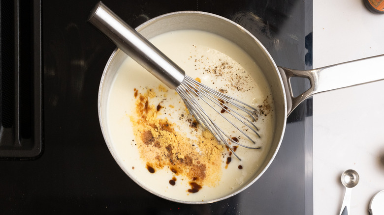 Whisking flavorings into white sauce