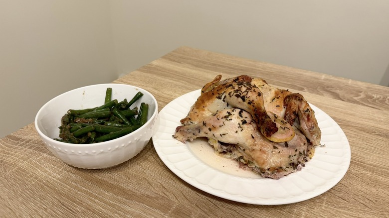 Whole chicken and bowl of vegetables