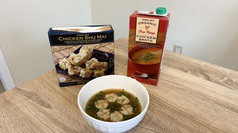 Bowl of soup with ingredient containers