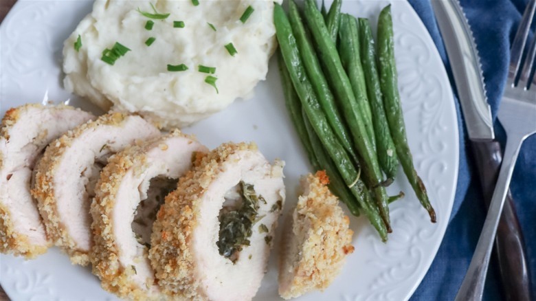 chicken kiev with green beans and mashed potatoes