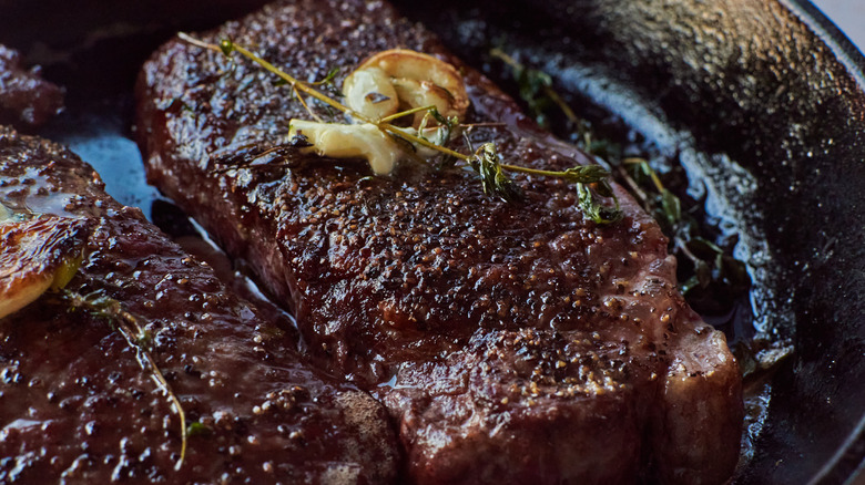 whole steak strip in cast iron pan