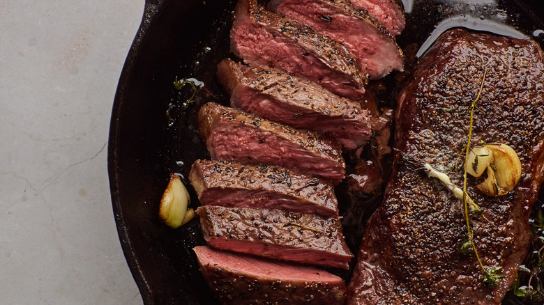 sliced steak in cast iron pan