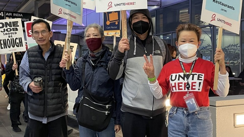 SFO workers striking carrying signs