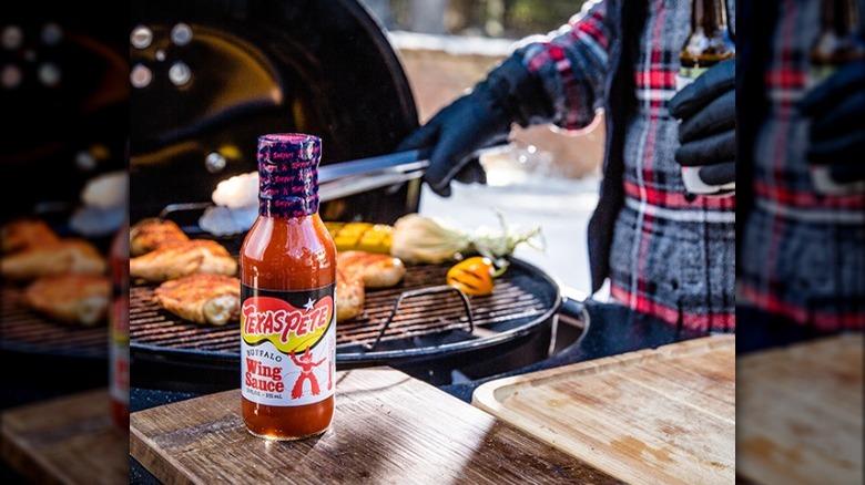 Texas Pete Buffalo Sauce next to grill