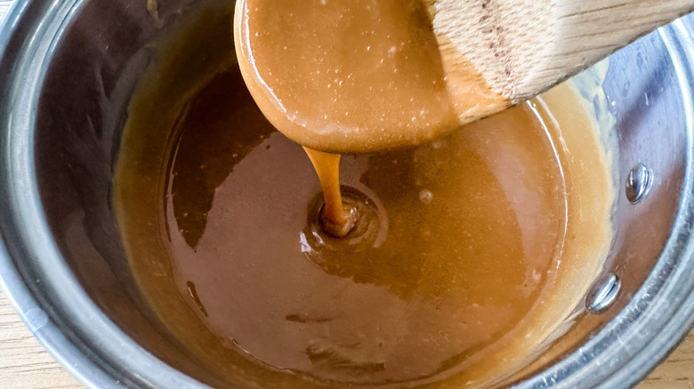 caramel sauce with wooden spoon