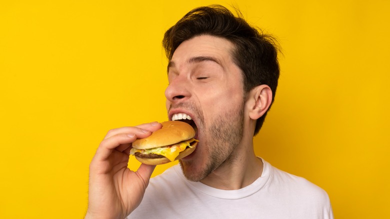 man eating burger