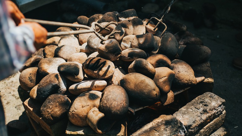 Heated rocks in pachamanca earth oven 