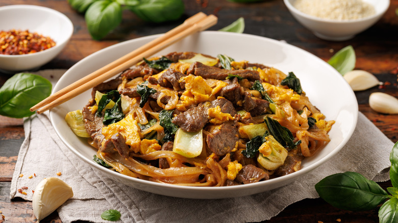A beef pad see ew with chopsticks on top
