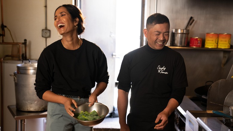 Padma Lakshmi smiling with chef on Taste the Nation 