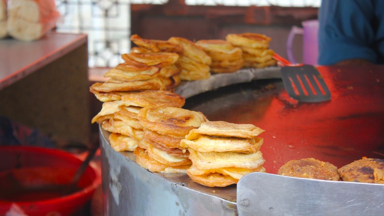 bun kebabs stacked on street cart