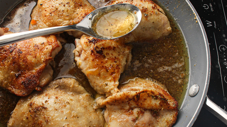 chicken with broth in skillet