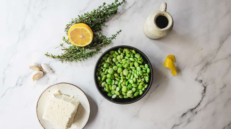 ingredients for pan-fried lima beans on marble counter