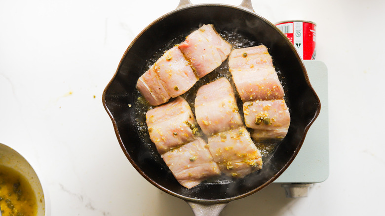 Mahi fillets cooking in pan