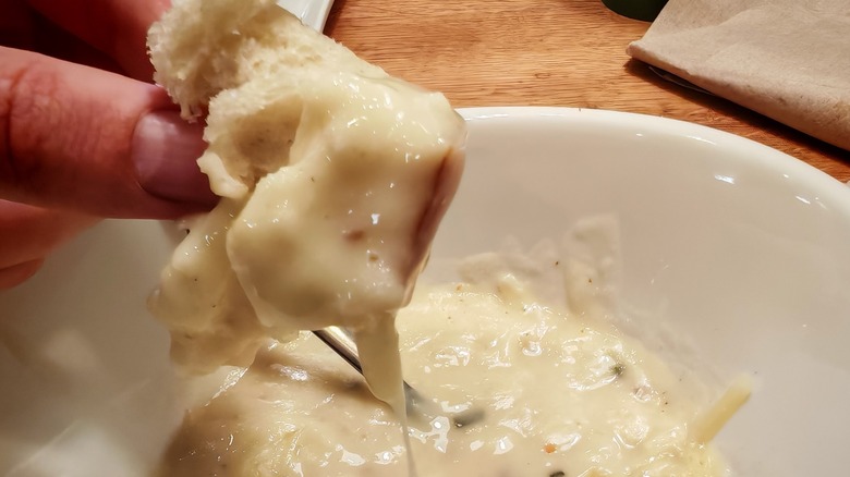 Rustic Baked Potato Soup coating bread