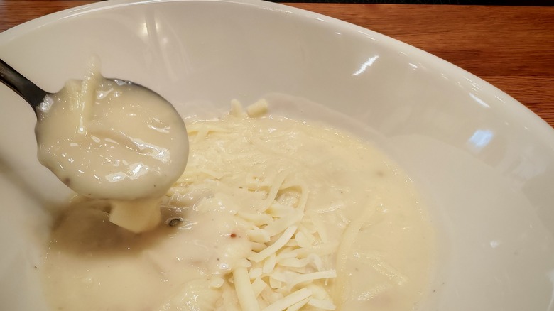 Panera potato soup dripping off spoon