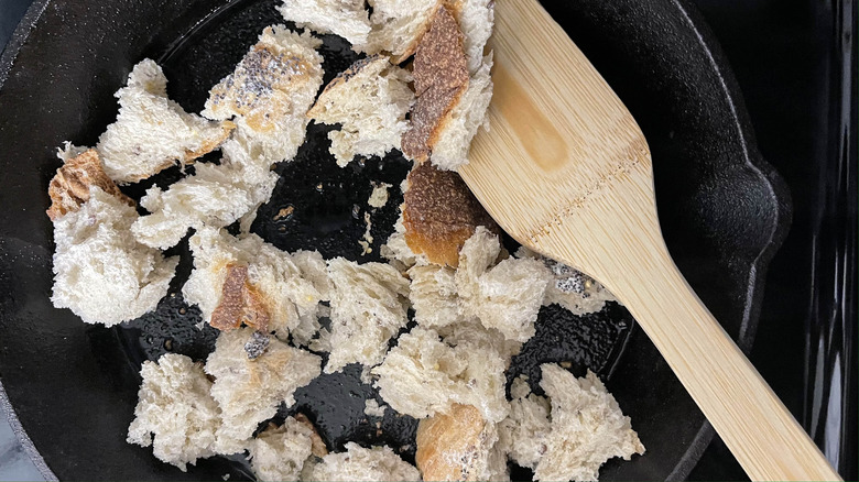 torn bread in skillet