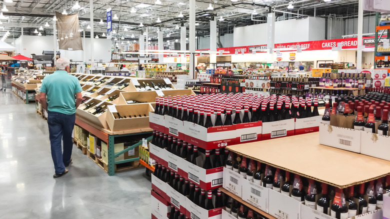 man checking liquor in Costco