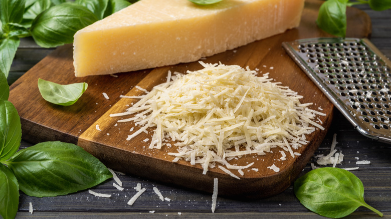 Grated parmesan cheese on a chopping board