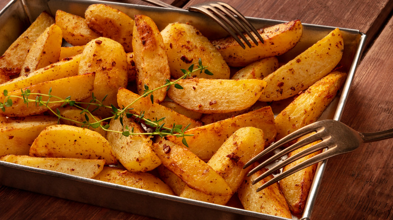 sliced potatoes baking sheet