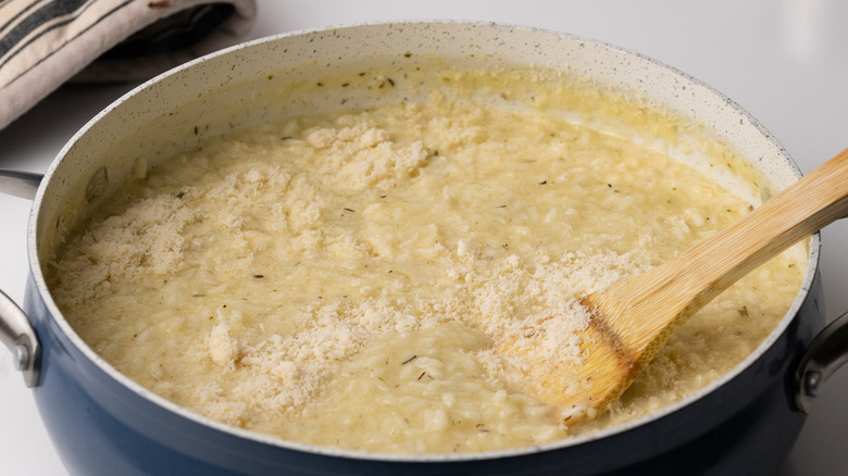 Stirring grated Parmesan into risotto