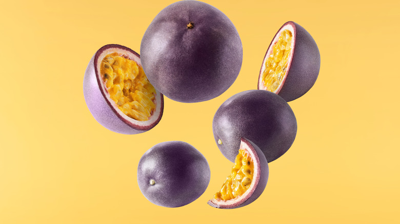 Passion fruit sliced and floating on a yellow background