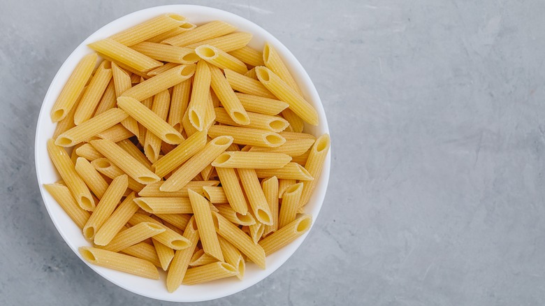 Penne pasta in bowl grey