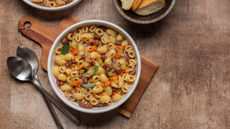 bowl of pasta e fagioli on cutting board