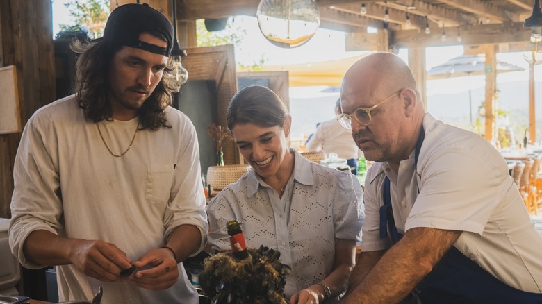 Pati Jinich and chefs smiling at border